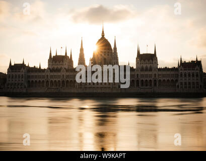 Sonnenaufgang hinter dem ungarischen Parlament und Donau, Budapest, Ungarn, Europa Stockfoto
