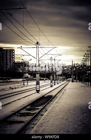 Blick entlang der Plattform und Eisenbahnlinien an einem Bahnhof in der Nähe von Stavanger, Norwegen im Winter. Stockfoto