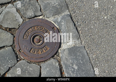 Bern, Schweiz - 23. Juli 2019: Benchmark auf der Straße Europapromenade in Bern, Schweiz. Mit diesen Landvermesser können das Land messen. Stockfoto