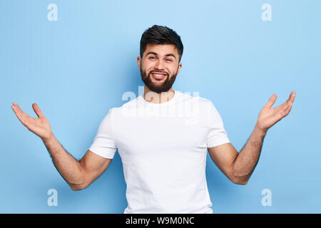 Junge fröhliche schöner Mann seine Hände heben mit open Palms, Gruß Freunde, willkommen Geste. auf blauem Hintergrund isoliert. nach oben Porträt schließen. Körper Stockfoto