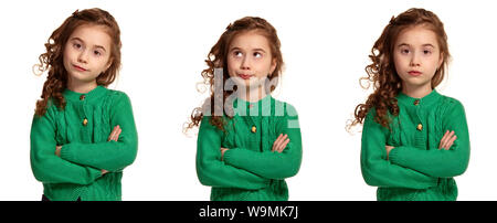 Porträt einer wunderschönen kleinen Mädchen in einem grünen Strickpullover auf weißem Hintergrund posiert. Stockfoto