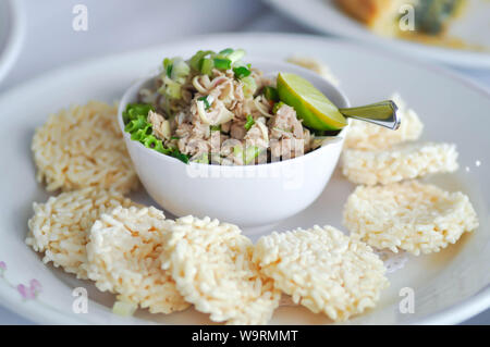 Knusprige Reis, knusprigen Reis Kuchen oder reiskräcker mit würzigen Thunfisch Salat im thailändischen Stil Stockfoto