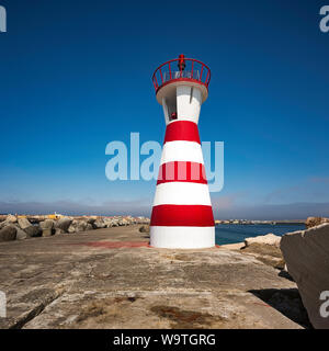 Der kleine Leuchtturm am Ende der Hafenmauer in Peniche Stockfoto