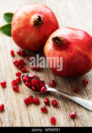 Saftig und reife Granatäpfel an einem alten Holztisch Stockfoto