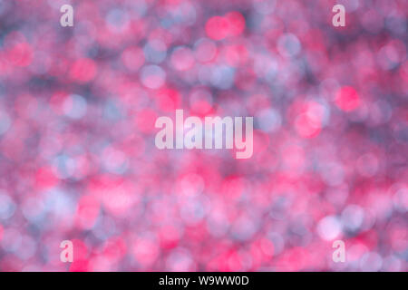 Bokeh Hintergrund Kreation mit reflektierender Folie und studio flash auf farbigen Gel in Rot, Rosa und Weiß. Stockfoto