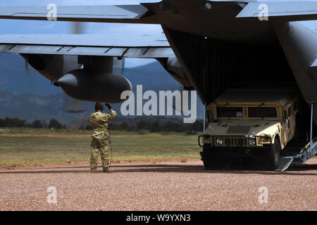 PETERSON AIR FORCE BASE, Colo.-- Flieger vom 302Nd Airlift Wing Hilfe der 13 Air Support Operations Squadron durch die Mission Qualifizierungsmaßnahmen durch Üben ein verfügbarkeitsplan Szenario Landung und Entladen einer C-130 Hercules Juli 17, 2019 in Fort Carson, Colorado. Die C-130 wurde die Tactical Air Control party Flieger, ein Humvee und Verbrauchsmaterialien für die Übung. (U.S. Air Force Foto von Airman 1st Class Andrew Bertain) Stockfoto