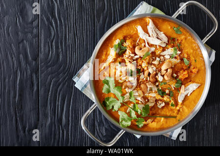 Die duftenden Indian Mulligatawny Suppe mit Curry gewürzt und von cremige rote Linsen, Karotten, äpfel und Kokosmilch, in eine Pfanne serviert. Stockfoto