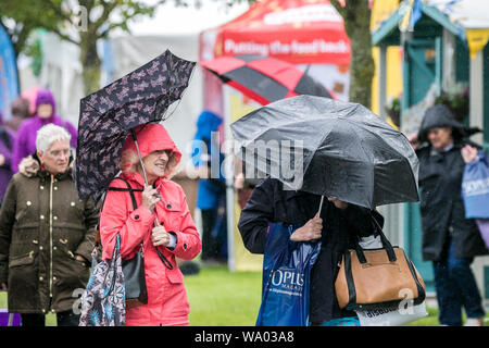 Southport, Merseyside, 16. August 2019. Starker Regen ergießt sich auf Besucher trotzen dem schrecklichen Wetter, wie sie ihren Weg in die 2019 Southport Flower Show machen. Das Vereinigte Königreich ist um mehr als einen Monat im Wert von Regen heute geschlagen zu werden - bevor das heiße Wetter Renditen für die Bank Holiday. Credit: cernan Elias/Alamy leben Nachrichten Stockfoto