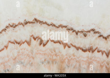 Dekoratives Licht braun, beige onyx Oberfläche, Textur auf Makro. Hochauflösendes Foto. Stockfoto