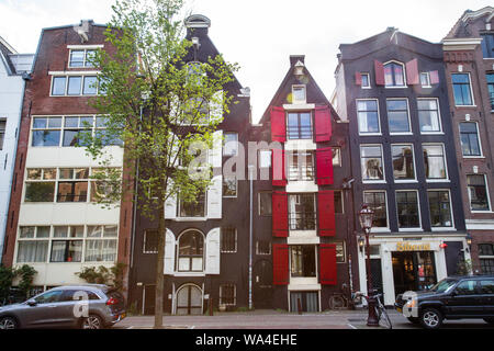 AMSTERDAM, NIEDERLANDE, 31. AUGUST 2018: die Reihe der traditionellen Gebäude von der Straße aus gesehen in Amsterdam. Stockfoto