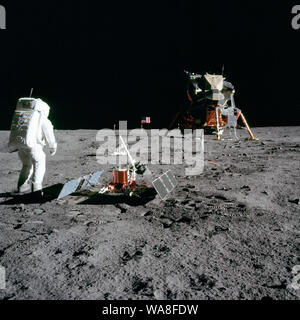 Astronaut Edwin E." "Buzz" Aldrin Jr., Lunar Module Pilot, ist während der Apollo 11 Extra Vehicular Activity auf dem Mond fotografiert. Er hat gerade im Einsatz, um die frühen Apollo wissenschaftliche Experimente Paket (EASEP). Im Vordergrund steht die Passiven seismischen Experiment Package (PSEP); darüber hinaus die Laser Ranging Retro-Reflector ist (LR-3); in der Mitte Hintergrund ist die Vereinigten Flaggenstaaten; im linken Hintergrund ist die schwarzen und weißen Mondoberfläche fernsehen Kamera; in der rechten Hintergrund ist die Mondlandefähre "Eagle". A. in der Astronaut Neil Armstrong, Kommandant, nahm dieses Foto mit 70 mm Lunar s Stockfoto
