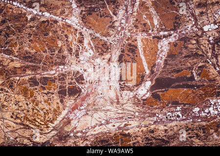 Zusammenfassung Hintergrund von braunem Stein. Granit, Marmor Textur, orange Muster. Mehrfarbige glatte Platte. Natürliche Mauer, moderne Stock. Dunklen Stein außen Stockfoto