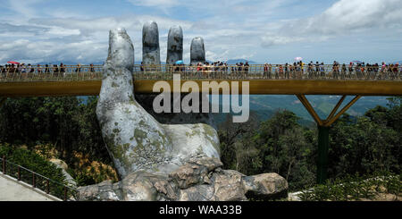 Da Nang, Vietnam - am 18. August 2018: Touristen in der Golden Bridge. Die Goldene Brücke ist eine 150 m lange Fußgängerbrücke in der Ba Na Hügeln in Da Nang. Stockfoto