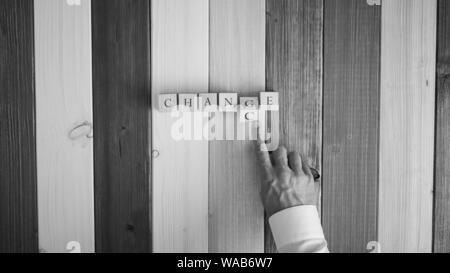 Hand eines Unternehmers spiegeln Holzwürfel mit Buchstaben G und C das Wort Chance in zu ändern. Stockfoto