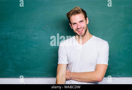 Meister der Vereinfachung. Mann Lehrer vor der Tafel. Vorteile für männliche Grundschullehrerin sind reichlich vorhanden. Lehrer interessante Lautsprecher Dozent. Zurück zu Schule. Lehre könnte mehr Spaß machen. Stockfoto