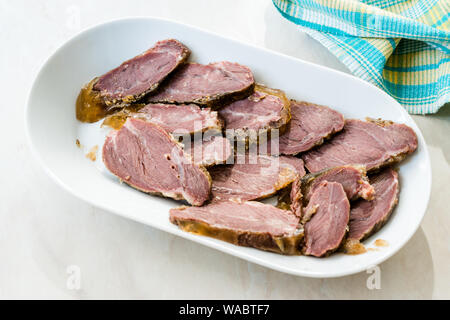 Geräuchertes Fleisch Kalbfleisch Wange Slices auf Holzbrett. Bereit zu Essen. Ökologische Lebensmittel. Stockfoto