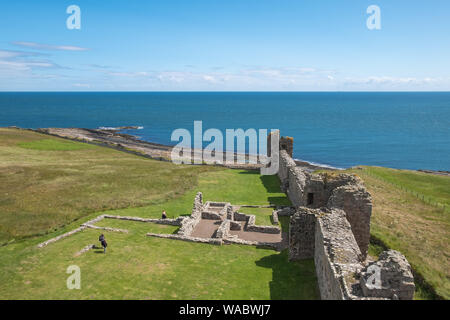 Blick auf das Meer und die Küste von Dunstanburgh Castle in der Nähe von Alnwick an der Küste von Northumberland, Großbritannien Stockfoto