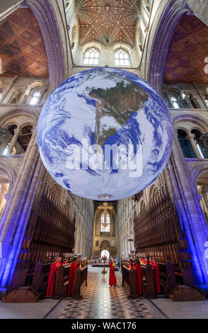 Chorknaben von der Kirche der Heiligen Dreifaltigkeit Coventry Proben für evensong als Gaia, ein 23 ft Replik des Planeten Erde hängt, auf der Kathedrale von Peterborough. Stockfoto