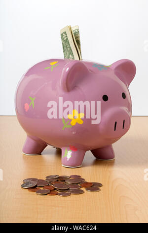 Ein Kind rosa Sparschwein mit Geld Stockfoto