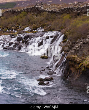 HUSAFELL, ISLAND - Wasserfall Hraunfossar, die aus Lava Feld. Stockfoto