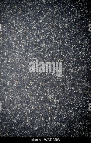Textured black background with white flecks in a shiny full frame abstract close-up Stockfoto