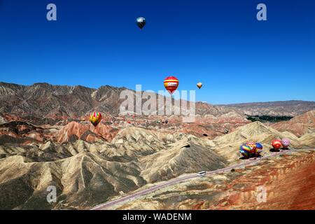 Ein Luftbild der beiden Ballons und Zhangye nationaler Geopark, die für seinen Danxia farbige Felsen bekannt ist, in Zhangye Stadt, Northwest China ¯ s Gansu p Stockfoto