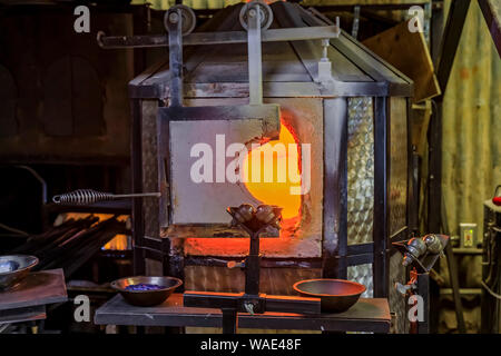 Glasbläserei Ofen und Tisch mit verschiedenen Glasbläserei Werkzeuge an die Werkstatt eines Glas Teekocher für die traditionelle Glasbläserei Prozess eingestellt Stockfoto