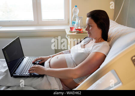 Schwangere Frau mit Computer im Krankenhaus, Karlsbad, Tschechische Stockfoto