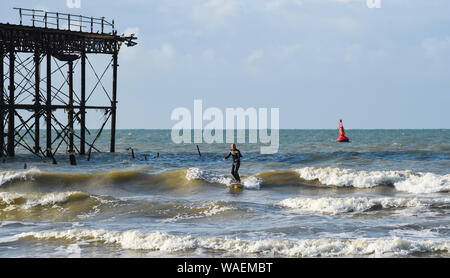 Brighton UK 20. August 2019 - ein Surfer genießt das Schöne am frühen Morgen Sonnenschein von Brighton West Pier als die Wettervorhersage in den nächsten Tagen insbesondere gegenüber der Bank Holiday Wochenende in Großbritannien Kredit zu verbessern: Simon Dack/Alamy leben Nachrichten Stockfoto