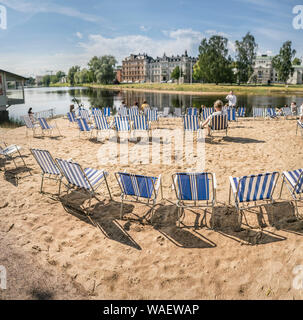 Menschen Entspannung am Strand im Zentrum von Karlstad durch den Fluss Klarälven. Värmland, Schweden, Skandinavien. Stockfoto