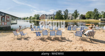 Menschen Entspannung am Strand im Zentrum von Karlstad durch den Fluss Klarälven. Värmland, Schweden, Skandinavien. Stockfoto