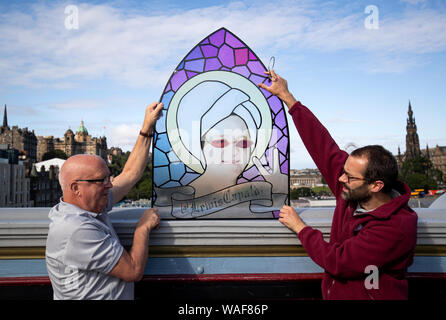 Center Manager Peter Recht (rechts) und sein Assistent Malcolm Moore einen genaueren Blick auf einen Fleck - Glasfenster, die schottische Sängerin und Songwriterin Lewis Capaldi. Das Fenster wird auf dem Display in der Schottischen Twitter Besucherzentrum am Edinburgh Fringe. Stockfoto