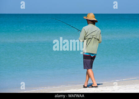 Nicht identifizierte lokalen jungen Mann bei Holmes Beach auf Anna Maria Island, Florida im seichten Wasser des Golfs von Mexiko. Stockfoto