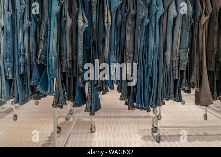 Reihe der Jeans oder Jeans und Hosen hängen an Haken. Verschiedene Jeans Einzelhandel Fashion Store. Zweite Hand Denim in Outlet Shop verkauft. Stockfoto
