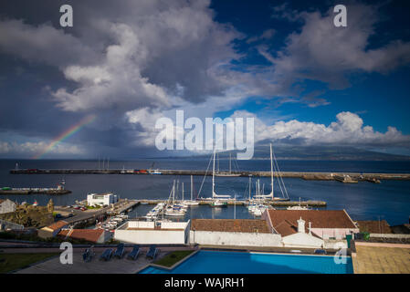 Portugal, Azoren, Insel Faial, Horta. Erhöhten Blick auf die Waterfront und den Vulkan Pico und Rainbow Stockfoto