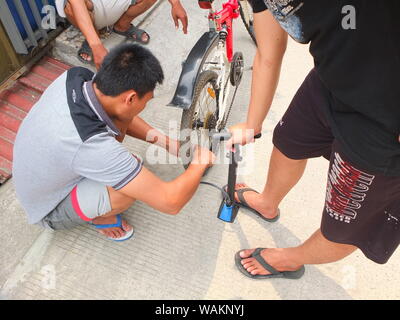 Menschen pumpen Fahrrad Reifen Stockfoto