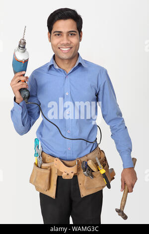 Elektriker mit Bohrer stehen und Lächeln Stockfoto