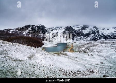 Montenegro, schöne kleine Tarn neben Bergmassiv abgedeckt durch Nebel im Nationalpark Durmitor abgedeckt durch weißen Schnee von sedlo Pass in der Nähe von Zab gesehen Stockfoto