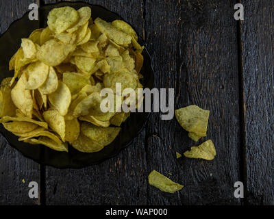 Kartoffelchips auf Holz- Hintergrund. Stockfoto