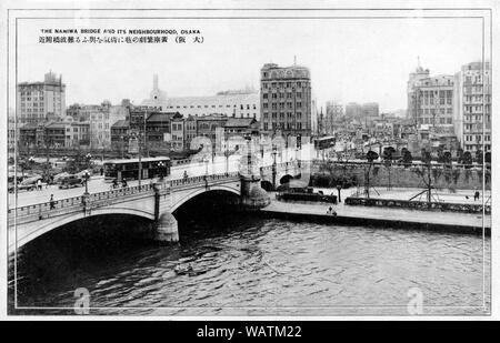 [1930er Jahre Japan - Moderne Brücke aus Stein in Osaka] - Naniwa Brücke in Osaka. Die Brücke überspannt den Alten Yodo Fluss und wurde 1915 abgeschlossen. Naniwa Brücke wurde vor allem für seine Strassenlaternen und Statuen von Löwen bekannt. Es kennzeichnete beeindruckende Steintreppe führt zu Nakanoshima Island und die Waterfront Park, die im Bau war zu der Zeit die Brücke gebaut wurde. Sie steht noch und ist eine der ältesten Brücken im westlichen Stil in Japan. 20. jahrhundert alte Ansichtskarte. Stockfoto