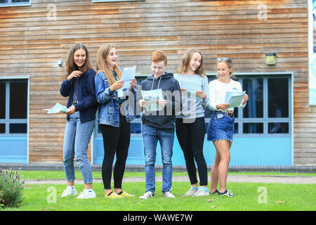 GCSE-Prüfung Ergebnisse Tag. Die Studierenden mit den Prüfungsergebnissen Buchstaben außerhalb einer weiterführenden Schule Stockfoto