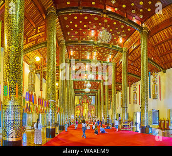 CHIANG MAI, THAILAND - Mai 2, 2019: Die reiche Innenausstattung von Phra Viharn Luang mit Reihen von riesigen Säulen, mit vergoldeten Blumen- und foliant Muster bedeckt, o Stockfoto