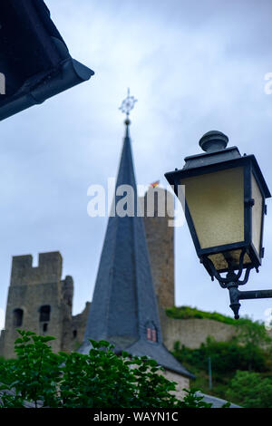 Street Light, Pfarrkirche Kirche und Löwenburg im Hintergrund das Schloss an der malerischen Ortschaft Monreal in der Eifel, Deutschland Stockfoto