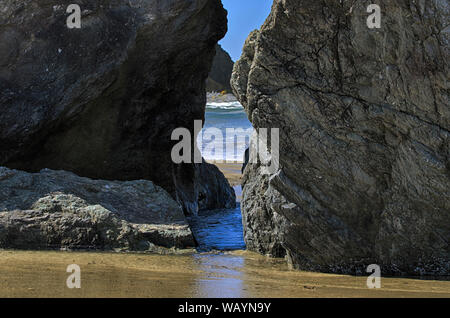 Sea Stacks ergeben sich aus dem Sand der Bandon Strand als eine Flut auf Sie wäscht, Bandon, Oregon. Bei Coquille, Oregon Inseln NWR Stockfoto