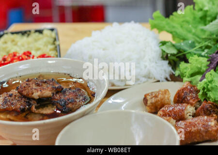 Bun cha, Vietnamesisch vermicelli mit gegrilltem Schweinefleisch serviert mit frischen Kräutern Stockfoto
