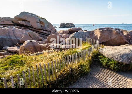 Blick über den Granit Blöcke entlang der GR34 Küstenweg, der 'Sentier des Douaniers", an der Küste des Rosa Granits in der nördlichen Bretagne, Frankreich. Stockfoto