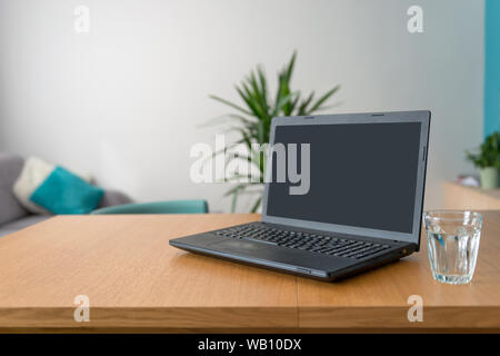 Laptop mit leerer Bildschirm am Tisch in der modernen Wohnzimmer. Bild horizontal Stockfoto