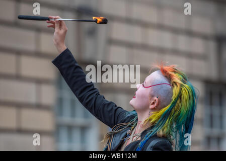 EDINBURGH, Schottland, Großbritannien. 21 August, 2019. Eine weibliche Feuer Esser, die für die Öffentlichkeit an Edinburghs Royal Mile während dem Festival F Stockfoto