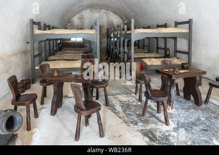 Dinant, Belgien - Juni 26, 2019: in der Zitadelle. Soldat barraks mit Etagenbetten und ein paar Tische und Stühle. Stockfoto