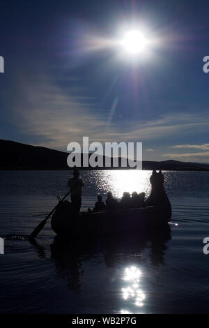 Sonnenuntergang von einer schwimmenden Uro Insel im Titicaca See. Die Uru oder Uros sind ein indigenes Volk von Peru und Bolivien, die auf eine ungefähre Hundert schwimmenden Inseln aus Totora-Schilf Reed, in der Nähe von Puno Titicaca See leben. Stockfoto